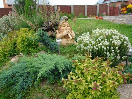 figures of wood in a flower garden
