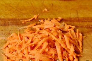 add the grated carrots to the cabbage