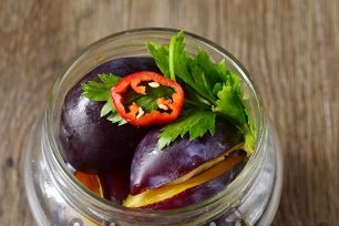 lay plums, pepper and greens