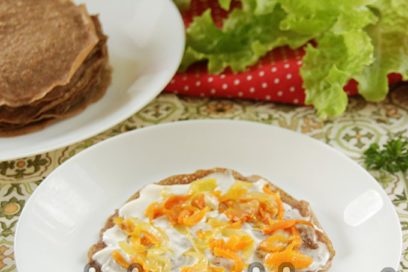 grease a pancake with sour cream with mayonnaise and put carrots with onions