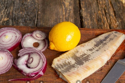 separate herring fillet, chop onion and lemon