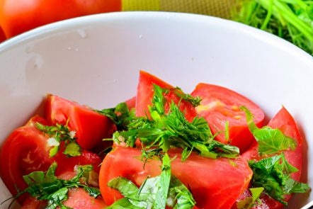 In a bowl, tomatoes and greens