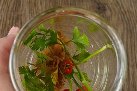 put greens and spices on the bottom of the jar