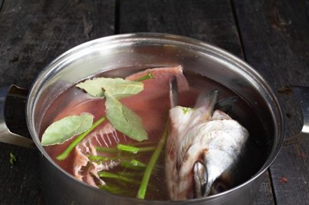 put the fish and greens in the water